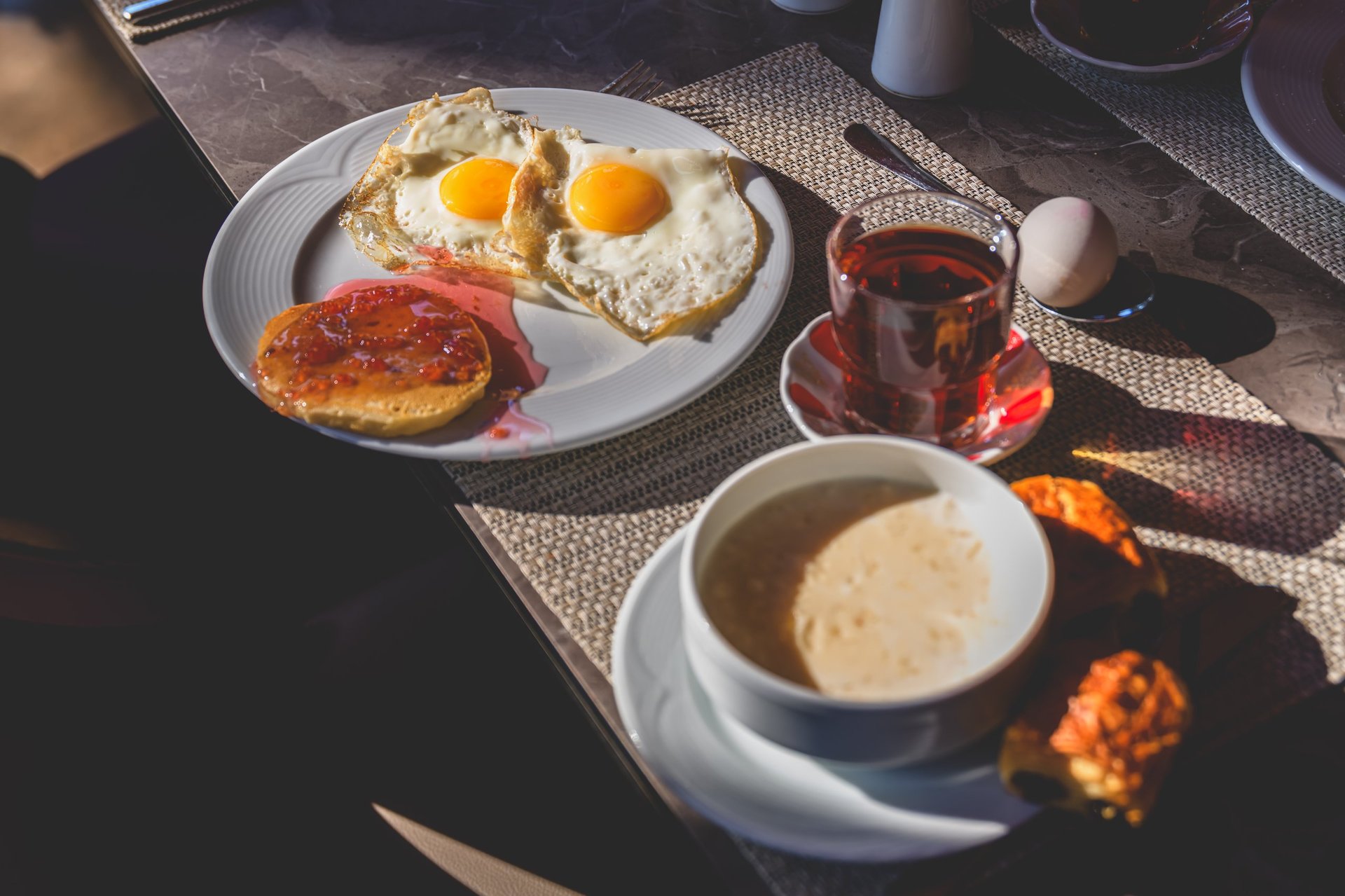 Beautifully set brunch table with eggs, pancakes, and fresh pastries